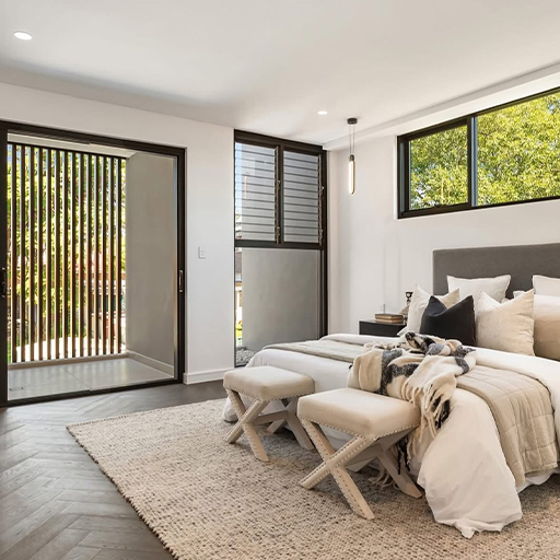 Master bedroom with herringbone flooring and garden access