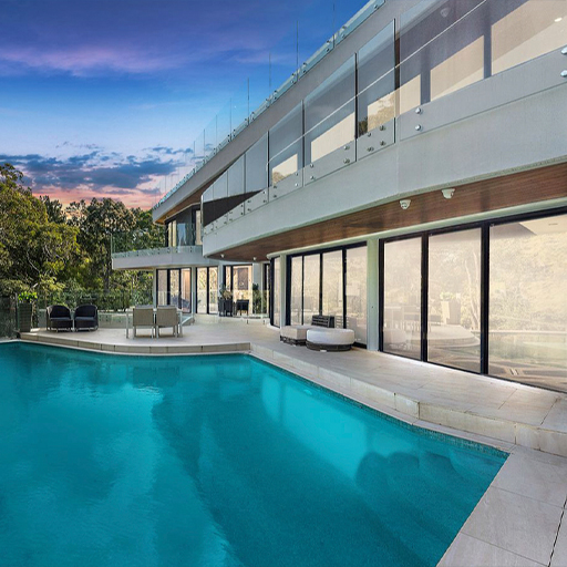 Poolside terrace of a contemporary residence with glass balustrades