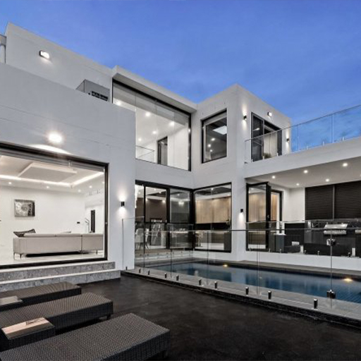 White rendered modern home with lap pool at twilight