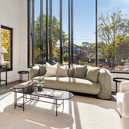 Bright living room with floor-to-ceiling windows and garden outlook